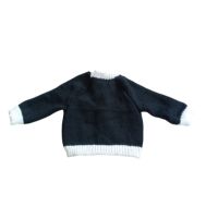 Black cardigan with white trim and lace edging.