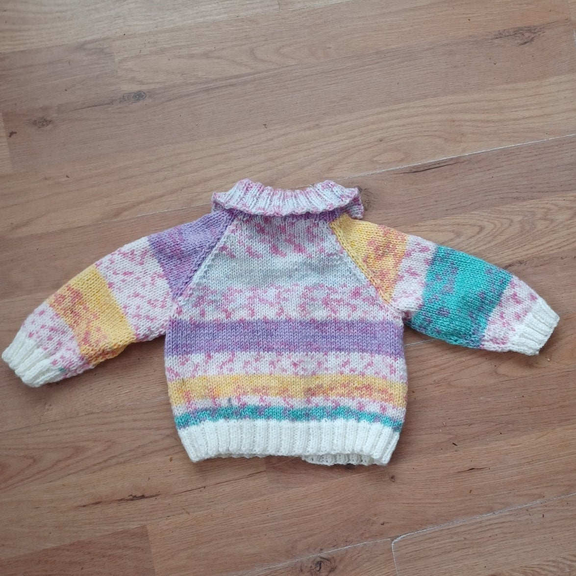 Cardigan hand knitted in soft self patterning yarn.