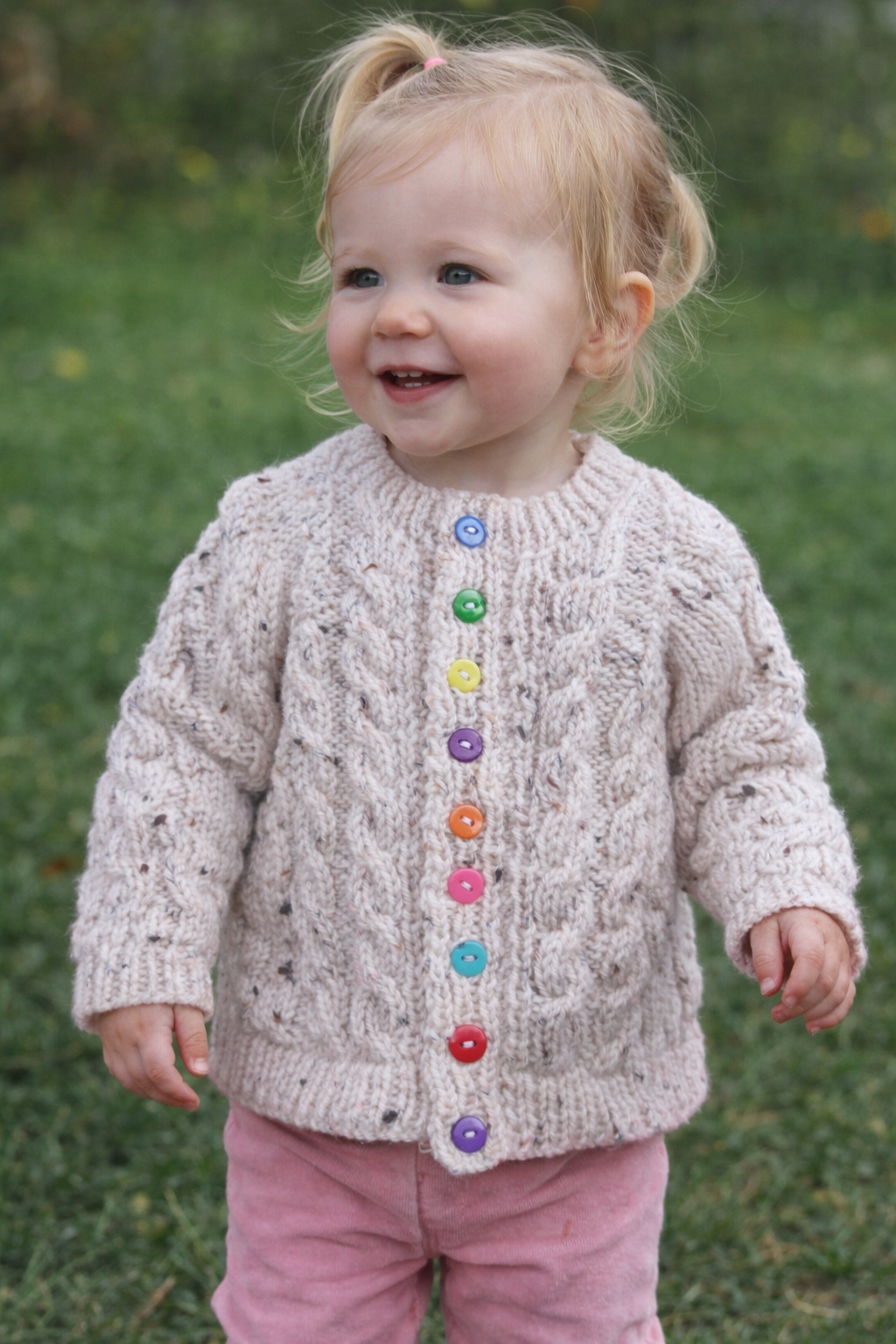 Lovely long sleeved Cardigan, in a tweed yarn with cable fronts panels and sleeves