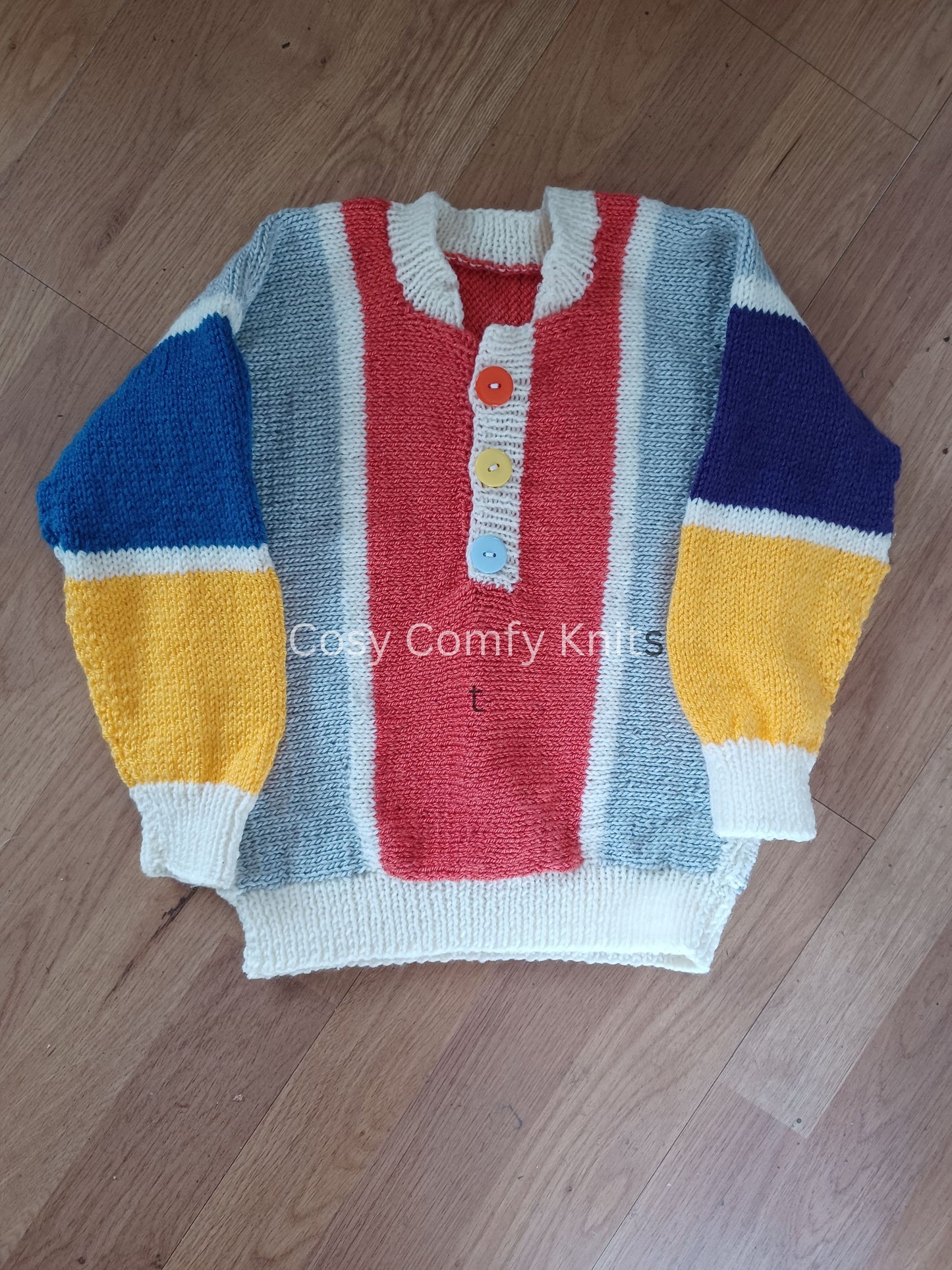 Colourful side to side hand knitted jumper in vibrant colours.