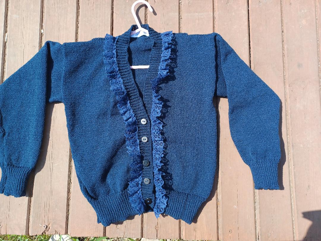 Lovely navy cardigan with a dash of lace added around the neck line, creating a distinctive look. Fabolous for home, play or school wear.