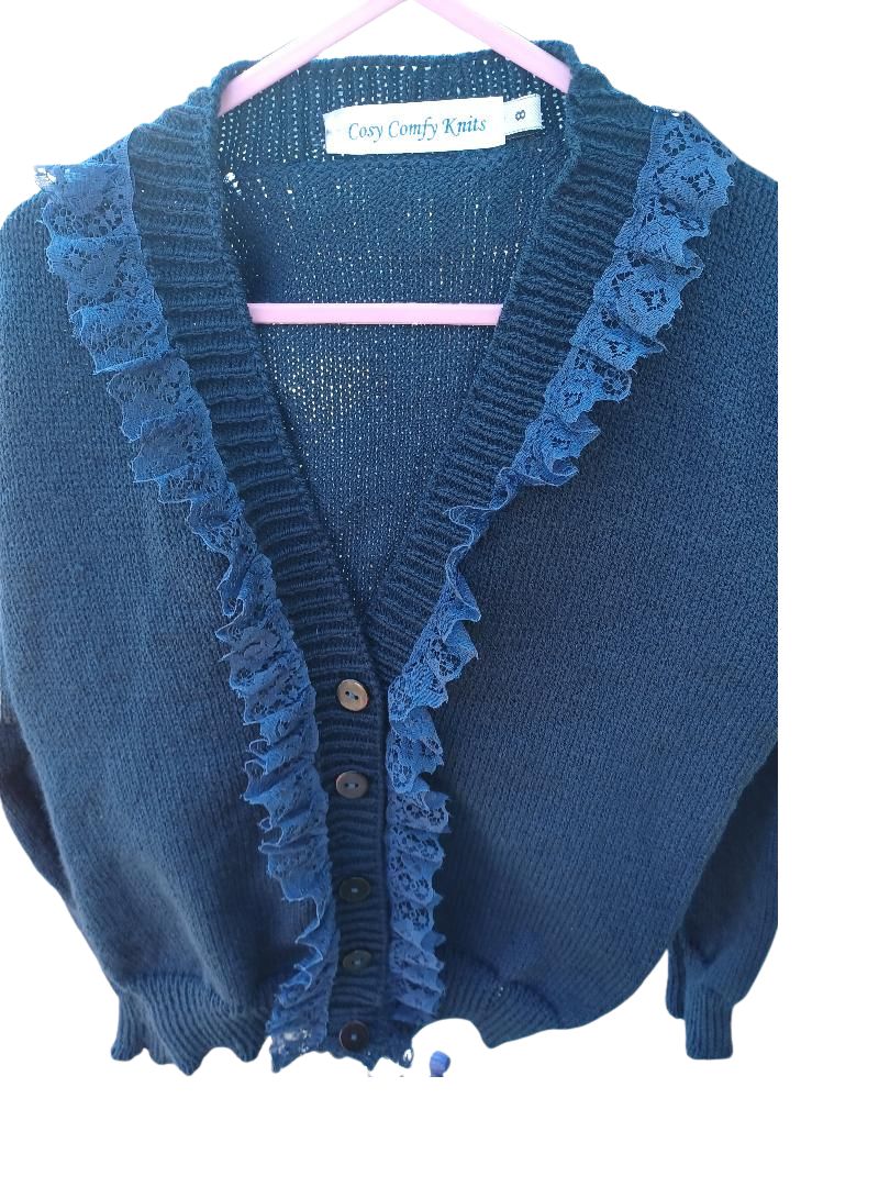 Lovely navy cardigan with a dash of lace added around the neck line, creating a distinctive look. Fabolous for home, play or school wear.