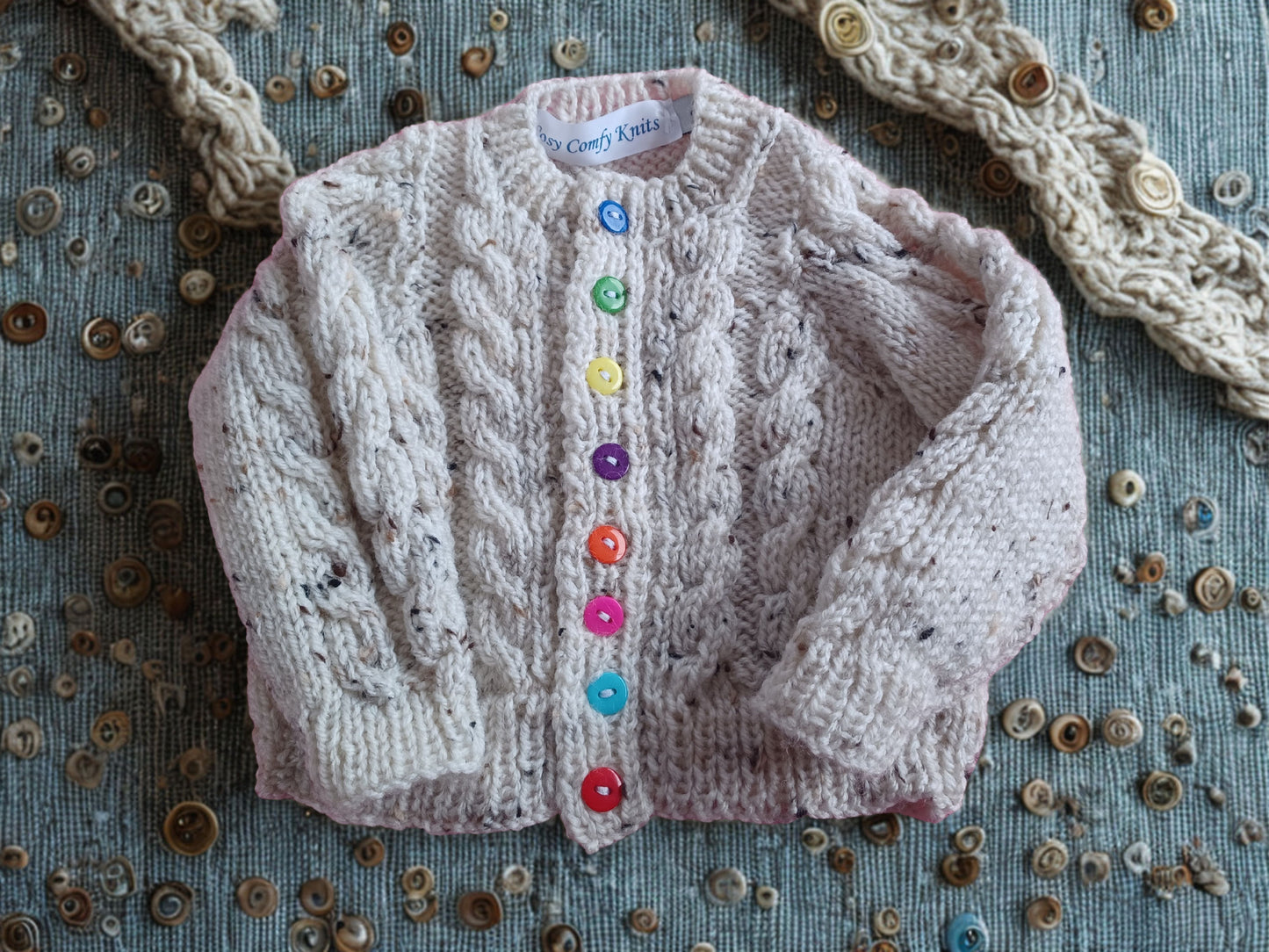 Lovely long sleeved Cardigan, in a tweed yarn with cable fronts panels and sleeves